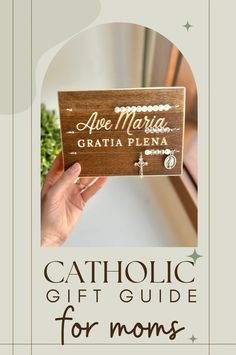 a wooden sign that says catholic gift guide for moms with the words, are martha gratia plena