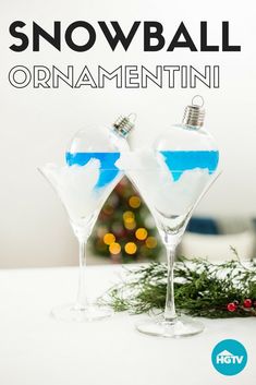 snowball ornament in martini glasses on a table with christmas tree behind it