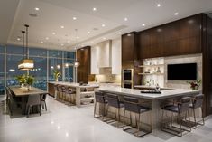 a large kitchen with an island in the middle and lots of counter space on each side