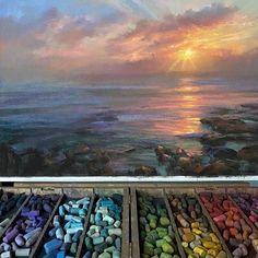 an oil painting of the ocean with pastel crayons in front of it