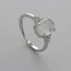 These is a beautiful Sterling Silver Ring with a Rainbow Moonstone Gemstone. The ring is made out of solid 925 Silver and there is no nickel or other substances causing most allergies. This makes the ring hypo allergenic. Size of the Moonstone 1.0 x 0.8 cm or  0.39 x 0.31 inch Please note: Our jewelry is photographed close up to show detail and may appear larger than they are. We use a dime coin as size reference on one of the pictures. You will receive the item in a gift box - perfect to surpri Rainbow Moonstone Ring, Moonstone Ring, Rainbow Moonstone, Rings Statement, Moonstone, Statement Rings, Natural Gemstones, Silver Ring, Sterling Silver Rings