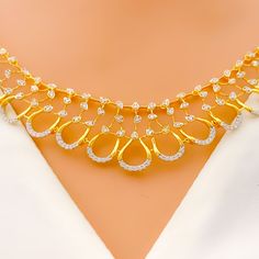 Featuring an 18k yellow gold necklace and matching earrings, this set weighs in at 24.3 grams. It is embellished with diamonds that total 2.07 carats, boasting a G-H color and VS quality, all cut in the round brilliant style. The necklace, measuring 17 inches, is designed with an elegant open drop style and is secured with a lobster lock, including three inches of adjustable links for the perfect fit. The set is accompanied by matching earrings, each 1.25 inches in length, with screw-back posts ensuring secure wear. This bright, open drop set combines classic elegance with contemporary design, making it a stunning addition to any sophisticated ensemble. PRODUCT DETAILS Gold Purity(karat): 18k Item Weight(grams): 24.3 Item Finish: Yellow Gold Stone: Diamond Diamond Weight(carats): 2.07ct Di Traditional Yellow Gold Necklaces With Diamond Accents, Yellow Gold Diamond Bridal Necklace For Celebration, 22k Gold Bridal Necklace For Anniversary, Yellow Gold Bridal Necklace With Diamond Accents, 22k Gold Diamond Cut Jewelry For Formal Occasions, Yellow Gold Jewelry With Diamond Accents For Celebration, Gold Bridal Necklace With Single Cut Diamonds, Dazzling Hand-set Yellow Gold Bridal Necklace, Hand Set Diamond Necklace In Yellow Gold