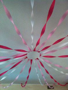 pink and white streamers hanging from the ceiling