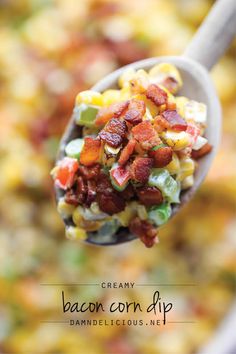 a spoon full of bacon and corn salad