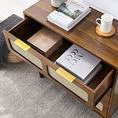 a coffee table with some books and a cup on it