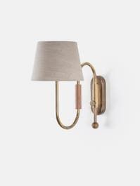 a wall light with a white shade on it's side and a gold arm