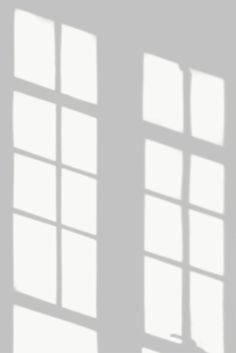 the shadow of an open window on a wall with white walls and panes in it