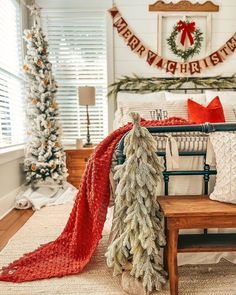 a living room decorated for christmas with white and red decorations