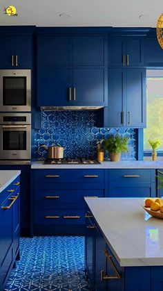 a kitchen with blue cabinets and white counter tops