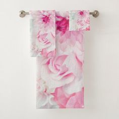 two pink and white towels hanging on a towel rack