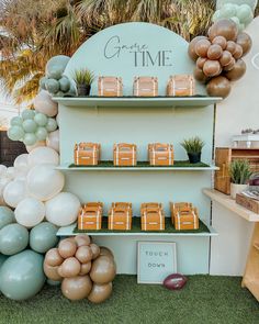 a table topped with balloons and plates filled with desserts next to a sign that says grand time