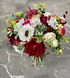 a bouquet of flowers is sitting on the ground