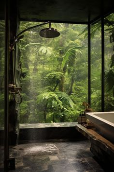 the bathroom is surrounded by lush green trees and plants, with a large window to let in natural light