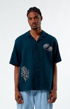 Introducing the Stitched Applique Oversized Camp Shirt, a stylish addition to your casual wardrobe. Crafted from soft cotton, it offers both comfort and durability. With its collared neckline, short sleeves, and oversized fit, this shirt provides a relaxed yet on-trend look. Complete with embroidered details throughout, it adds a touch of texture and interest to any outfit. 


	Collared neckline
	Short sleeves
	Standard fit
	Button closures
	Embroidery throughout
	100% Cotton
	Machine washable
	Model is wearing size medium
	Model Measurements: 6'1” Height, 31” Waist, 32” Inseam Oversized Shirts Men, Oversized Shirt Men, Pacsun Mens, Oversized Shirts, Embroidered Details, Camp Shirt, Swim Shop, Zara Man, Menswear Fashion