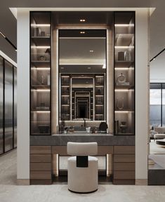 a bathroom with a large mirror, sink and vanity in the middle of the room