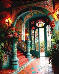 an ornate entry way with stained glass windows and potted plants