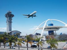 an airplane is flying over the airport