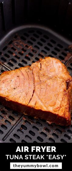 a piece of meat is being cooked on an outdoor grill with the words air fryer tuna steak easy