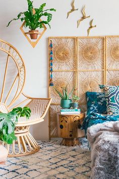 a bed room with a wooden headboard next to a chair and potted plant