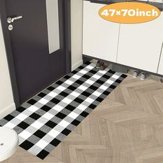 a bathroom with a black and white checkered rug on the floor next to a toilet