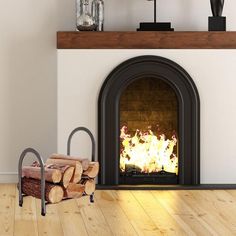 a fireplace with logs on the floor next to it