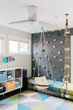 a child's bedroom with a swing bed and colorful rugs