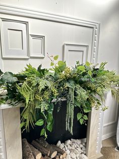 a fire place with plants and rocks in it