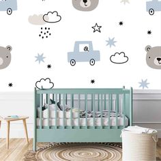 a baby's room with a crib and wall decals