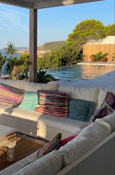 a couch sitting on top of a wooden floor next to a swimming pool