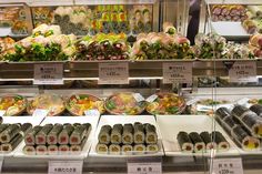 sushi and other foods on display in a store