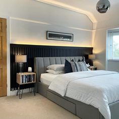 a bedroom with a large bed and two nightstands