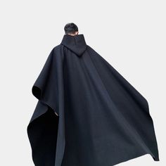 Long Techwear Poncho Oversized Hooded Cape For Cold Weather, Oversized Solid Color Cape, Oversized Black Winter Cape, Black Hooded Cape For Fall, Black Winter Cape For Outdoor, Hooded Black Cape For Fall, Black Winter Outdoor Cape, Black Cape For Cold Weather In Fall, Oversized Black Cape For Cold Weather