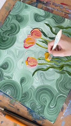 someone is painting flowers with acrylic paint