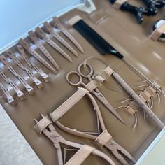 scissors and other tools are laid out on a table with the handles still attached to them