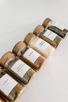 the spices are lined up on the counter for sale in the store or to be sold