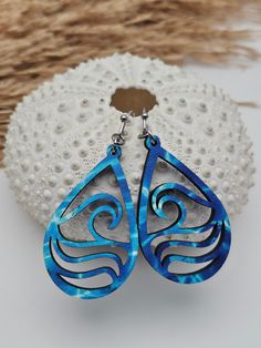 Add a touch of seaside charm to your look with these stunning Ocean Wave Earrings. Handcrafted with lightweight wood, these coastal-inspired earrings capture the essence of summer with their intricate wave design. Whether you're strolling along the shores of Florida or California, these Ocean Earrings are the perfect accessory for any beach lover or ocean enthusiast. They make a thoughtful gift for her, ideal for surfers and anyone who adores the natural beauty of the ocean. Bring a piece of the Single Dangle Earring For Beach, Ocean-inspired Adjustable Drop Earrings, Ocean-inspired Dangle Single Earring, Ocean-inspired Single Dangle Earring, Beach Teardrop Jewelry With Ear Wire, Beach Dangle Teardrop Earrings With Ear Wire, Dangle Earrings For The Beach, Teardrop Ear Wire Jewelry For Beach, Pierced Dangle Earrings For Beach