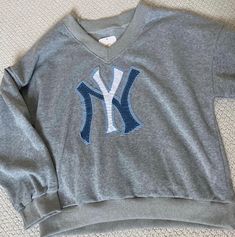 the new york yankees sweatshirt is laying on the floor