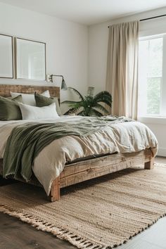 a bedroom with a large bed and two mirrors on the wall above it, in front of a window