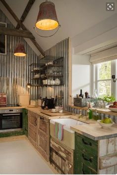 an old fashioned kitchen with green cabinets and white counter tops is pictured in this image