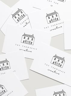 six white envelopes with black ink drawings of houses on them and the words, the house is for everyone