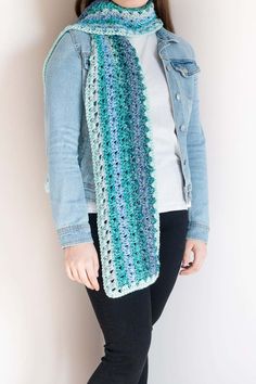 a woman wearing a blue and green crochet scarf with text overlay that reads, ombre crochet scarf pattern