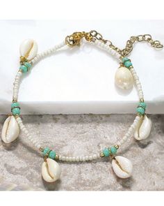 Accent your spring or summer look with this coastal-inspired, cowrie shell anklet from Periwinkle by Barlow that's finished with natural shells that dangle freely and colorful, seed beads.One size fits mostLobster claw clasp with adjustable length White Bohemian Beaded Bracelets With Lobster Clasp, Ocean-inspired Beaded Anklets For Summer, Summer Ocean-inspired Beaded Anklets, White Shell Beaded Bracelets For Summer, Summer White Shell Beaded Bracelets, White Cowrie Shell Beaded Bracelet For Beach, White Cowrie Shell Beaded Bracelets For Vacation, Bohemian Cowrie Shell Beaded Bracelets For Summer, Bohemian Cowrie Shell Beaded Bracelet For Summer