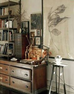 a living room with an old dresser and bookshelf