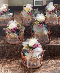 six baskets with flowers in them sitting on some steps