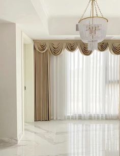 an empty room with curtains, chandelier and marble floor