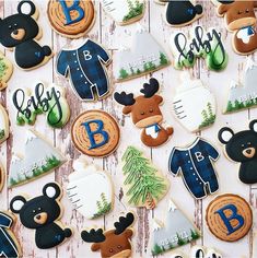 decorated cookies are arranged on a table with bear, deer and snowflake designs