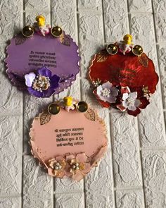 three small plaques with flowers on them sitting on a tile floor next to each other