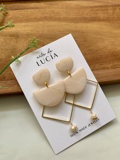 a pair of earrings sitting on top of a card