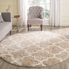 a living room with a chair and rug on the floor