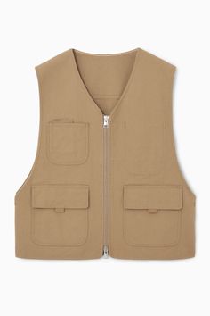 Informed by utility, this hybrid gilet is an ideal wardrobe solution for the transitional months. It's crafted from hard-wearing cotton-canvas in a versatile khaki hue and punctuated with a number of pockets in homage to its workwear roots. It can be styled in several ways, owing to the two-way zip and practical snap studs at either side. Two-way zip closureA better alternative to conventional polyester, recycled polyester is made from pre‐ and post‐consumer waste Shell: 80% Cotton, 20% Recycled polyester. Excluding trims / Machine wash Back length of size M/L is 67.5cm / Model wears a size M/L Utility Outfit, Outfit Hombre, Wardrobe Solutions, Ideal Wardrobe, Denim Suit, Utility Vest, Vest Shirt, Tshirt Skirt, Pant Shirt